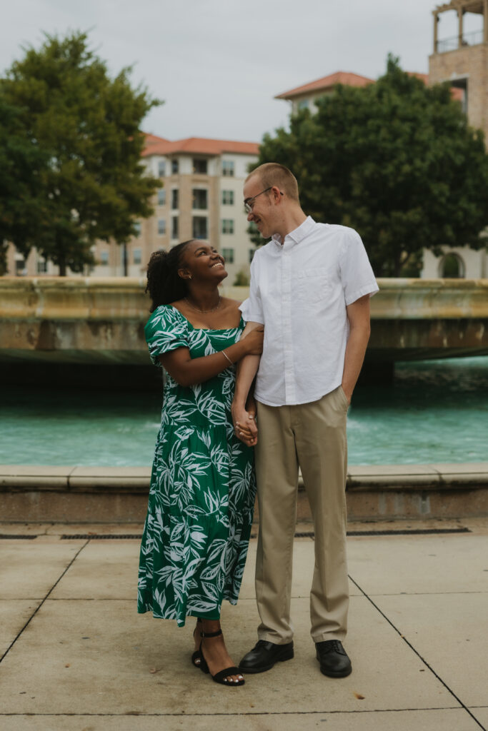 Engagement photoshoot in front of a fountain at The Harbor in Rockwall, Texas