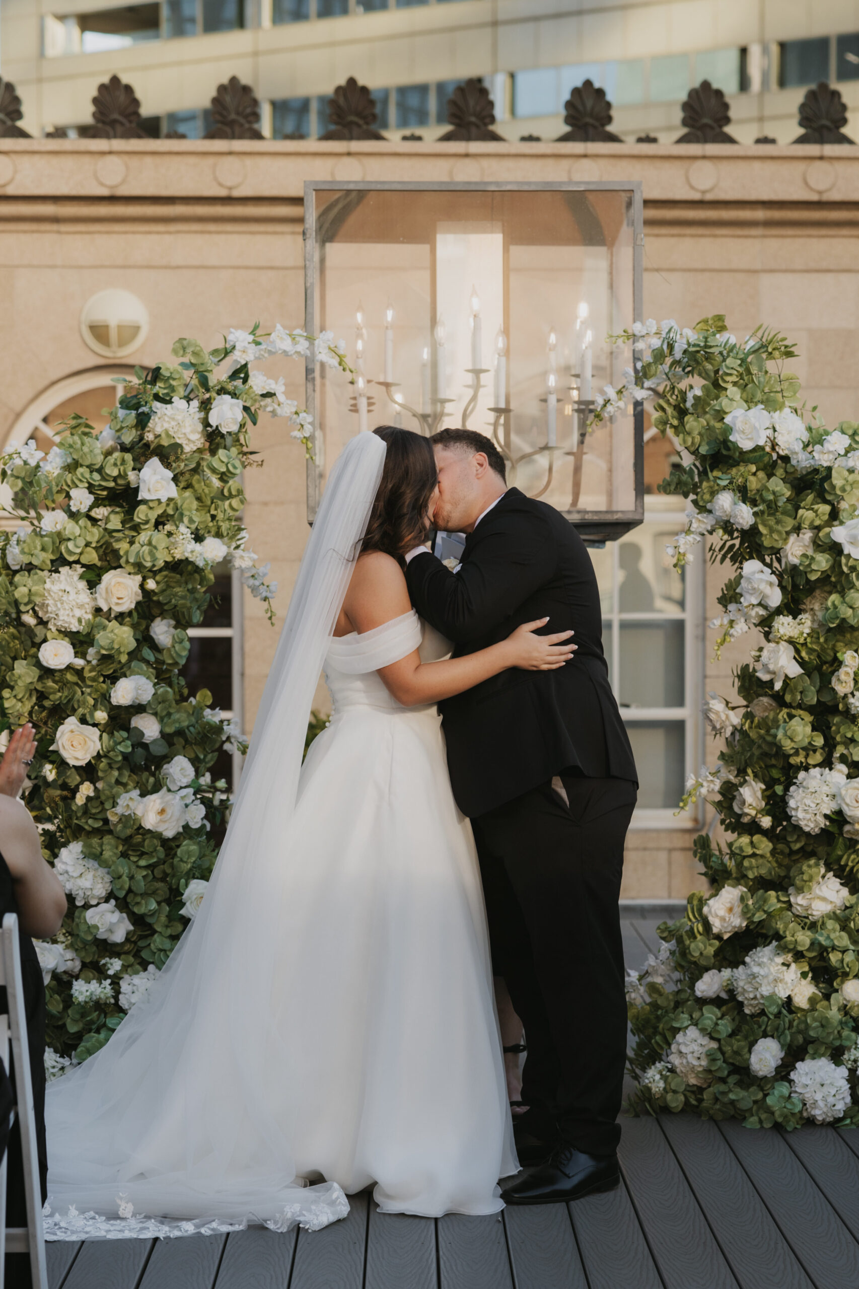 Couple kissing at the altar during their wedding ceremony