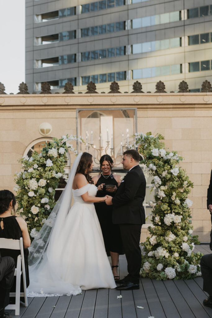 Couple during their rooftop wedding ceremony in downtown Dallas