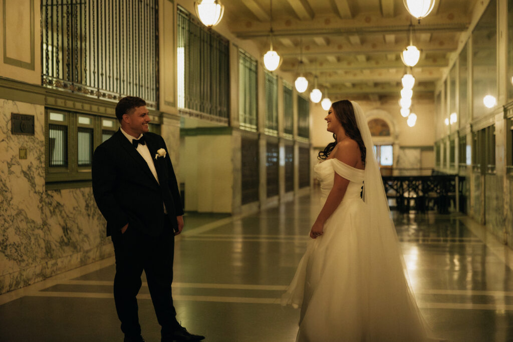 Bride and groom smiling at each other at a wedding venue in downtown Dallas