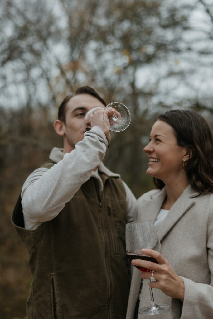 couple enjoying wine after engagement photoshoot