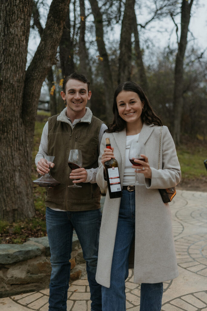 couple enjoying wine after engagement photoshoot