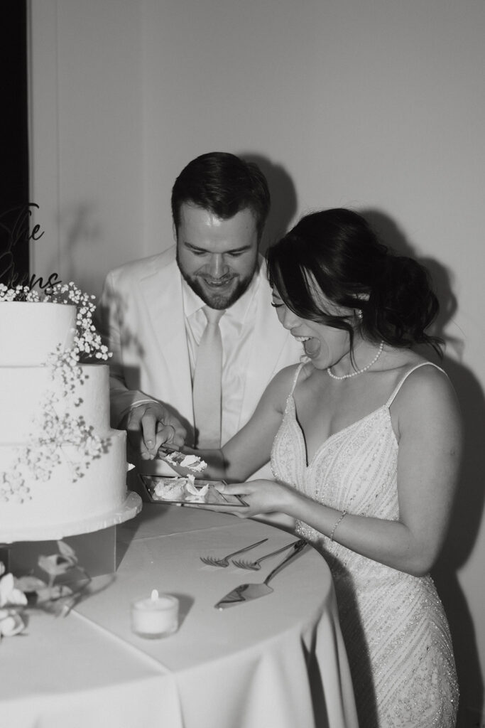 bride and groom cutting the cake during reception