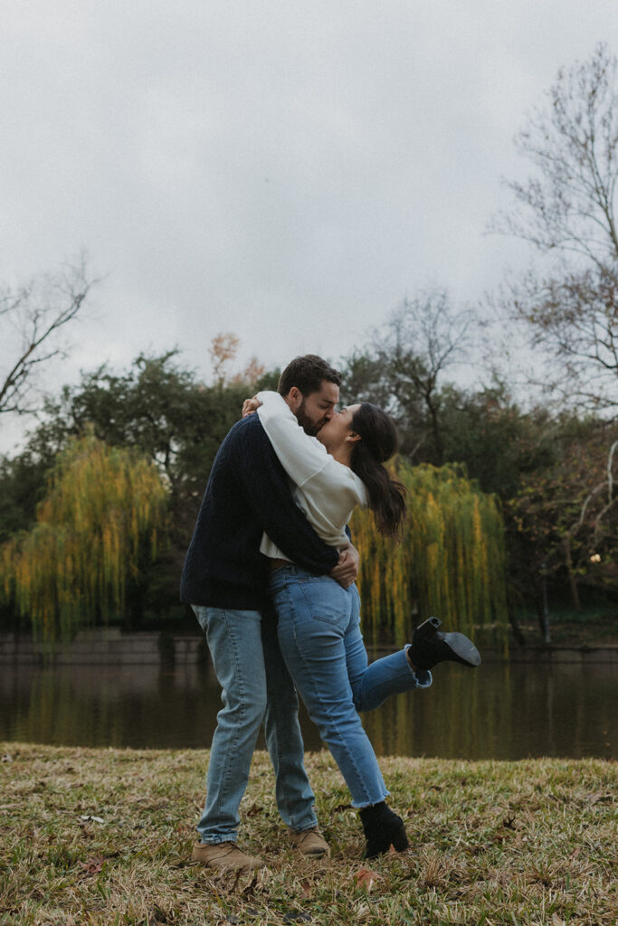 couple kissing by the lake for engagement session