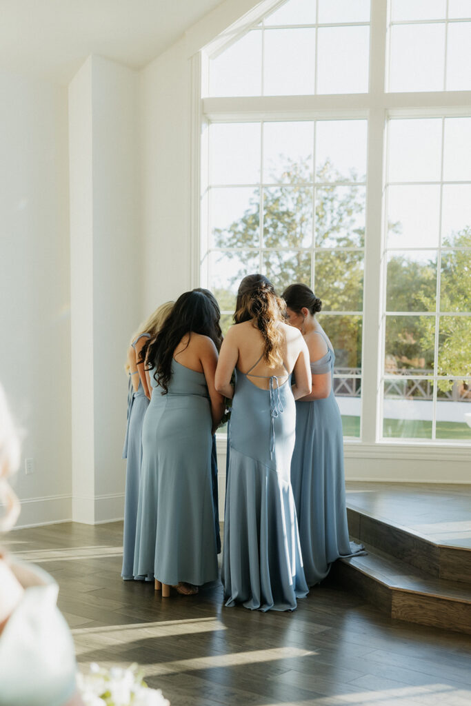 bridesmaids huddling and praying during the ceremony