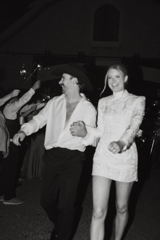 vintage film inspired black and white wedding exit photos with sparklers