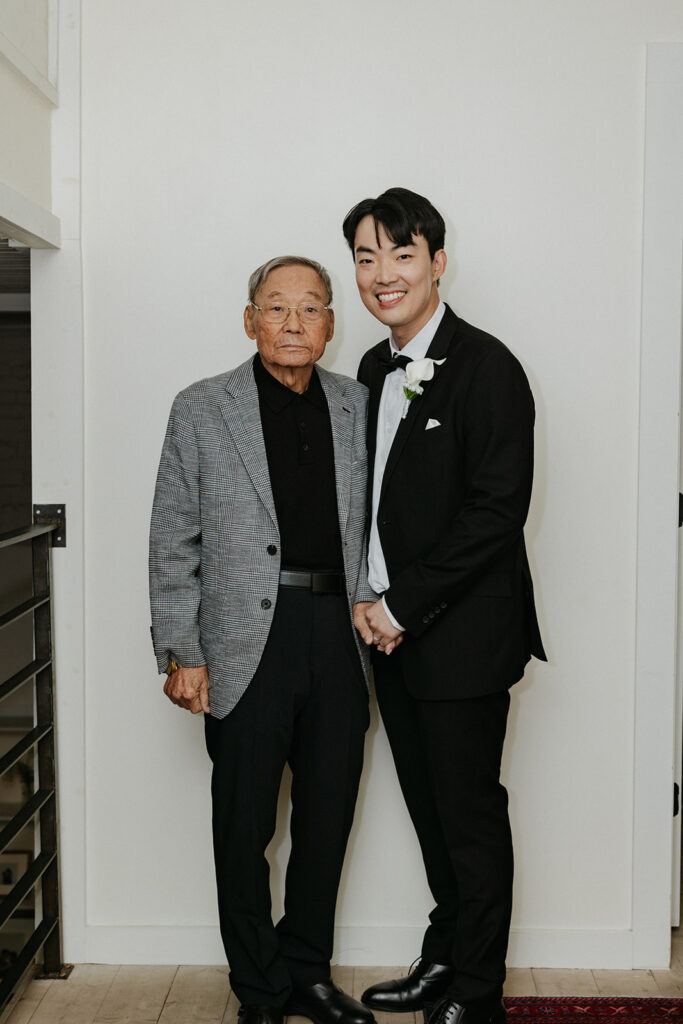 Groom smiling with his grandfather who is visiting all the way from Korea.