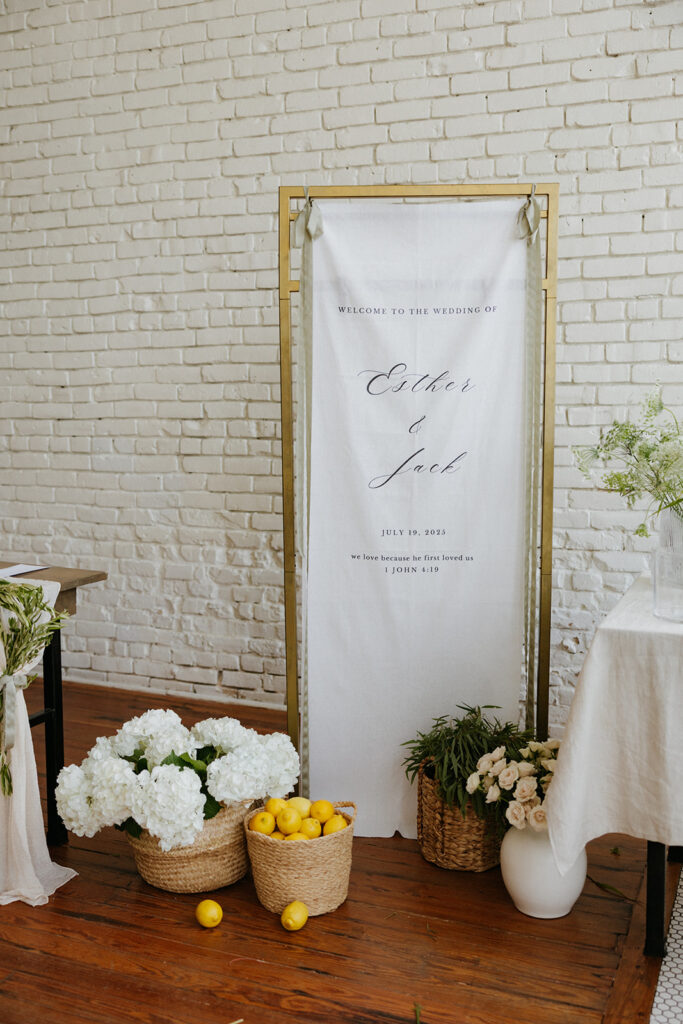 Wedding signage and flowers displayed for the classic wedding at One Eleven East Hutto Texas.