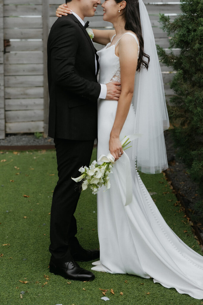 Bride and groom holding each other and looking into their eyes at One Eleven East Hutto, Texas.