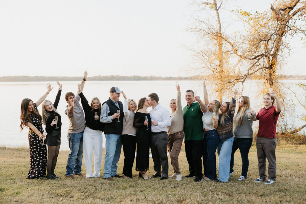 Friends and family celebrating the engaged couple and their proposal photos at Lake Waco.