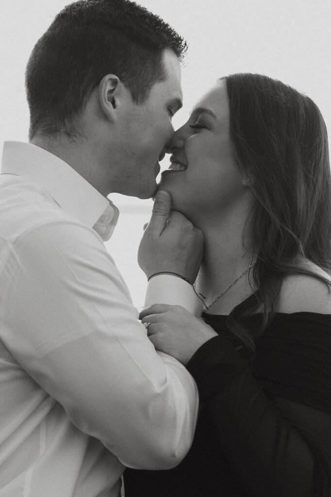 Couple going in for a kiss during proposal photos.