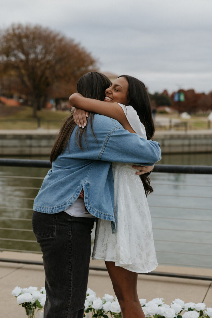 A woman hugging her best friend who came to celebrate the romantic proposal.