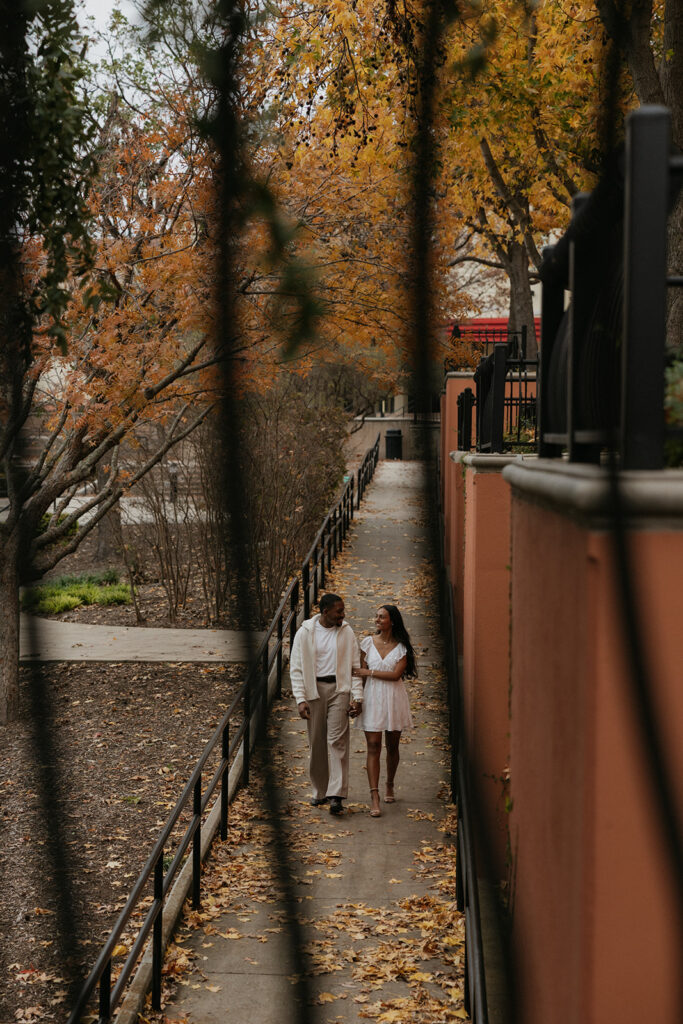 The couple walking hand in hand at The Harbor in Rockwall.