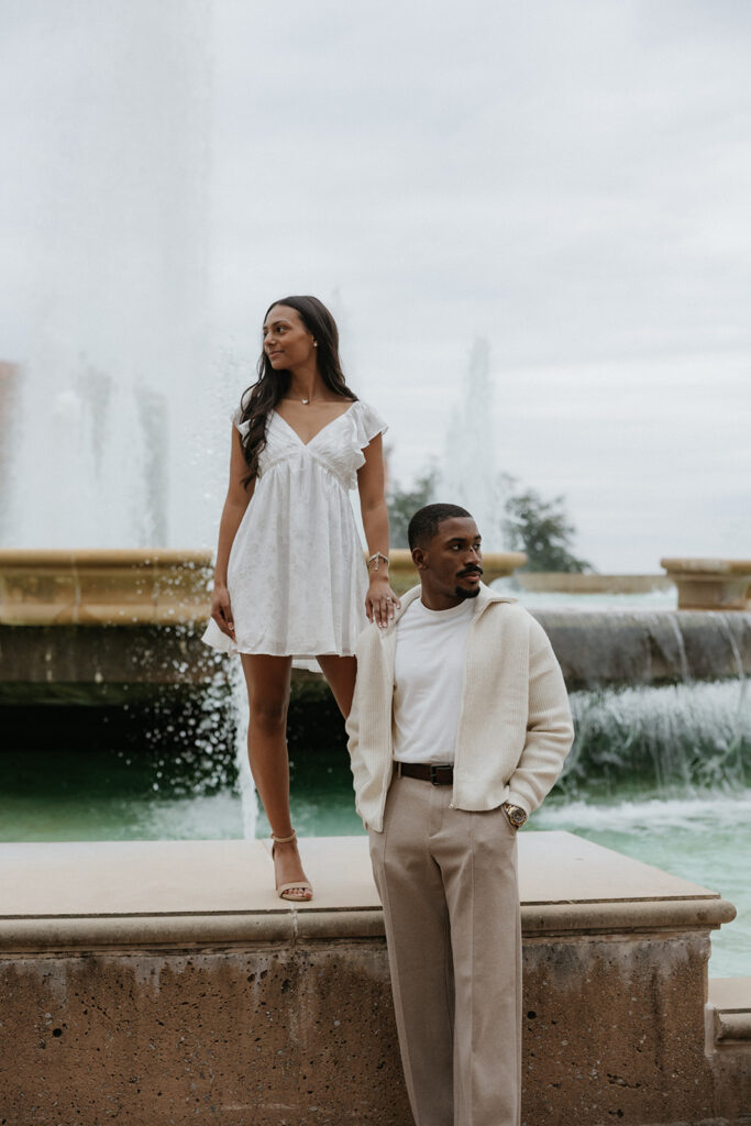 The couple looking off into the distance at the large fountain at The Harbor in Rockwall.