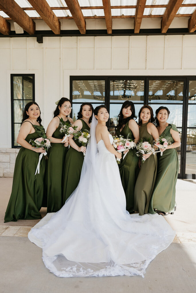 Bride and her bridesmaids holding colorful bouquets. 
