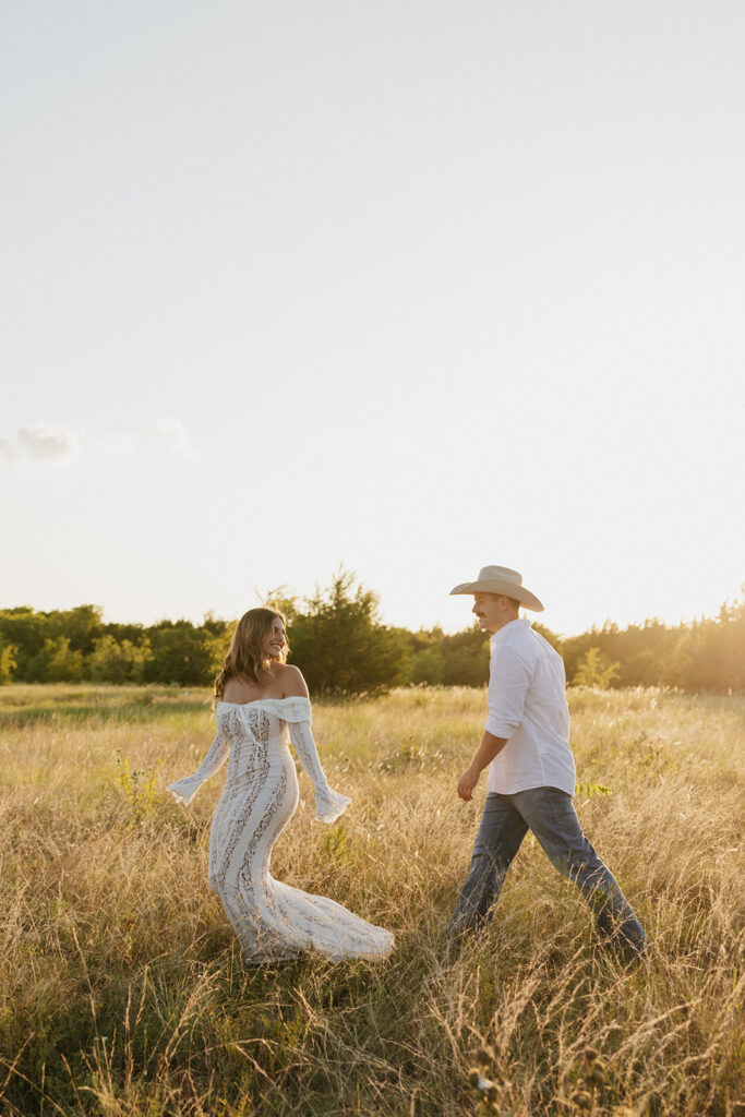 Man playfully walking towards his fiancée.