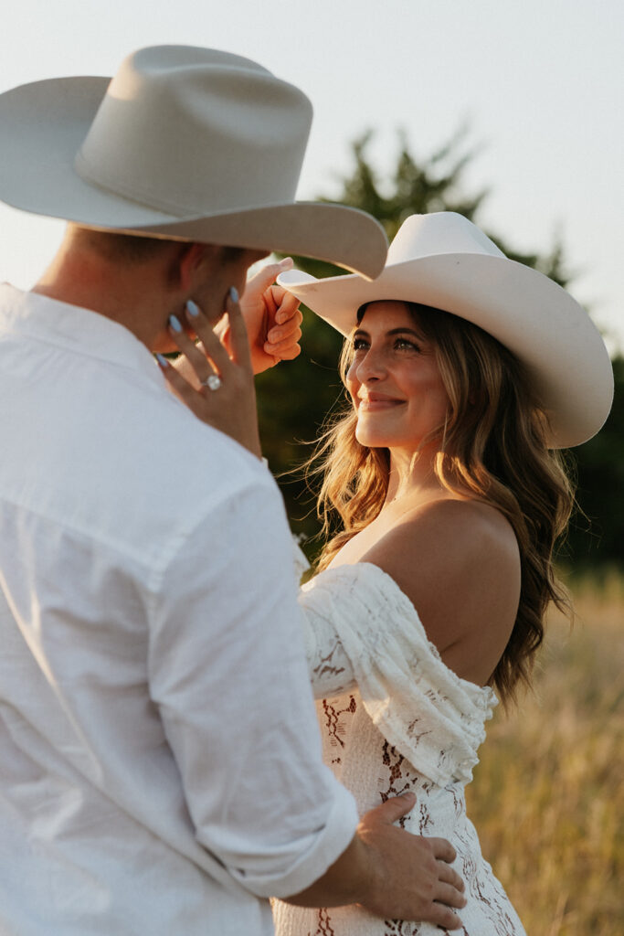 Woman romantically looking into the eyes of her fiancé during golden hour in Dallas.