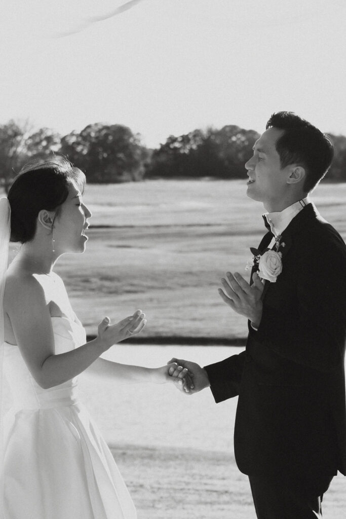 Couple holding hands while they worship God during their wedding ceremony at Bella Cavalli Events.