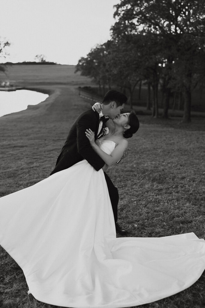 Groom dipping his bride for a kiss at Bella Cavalli Events.