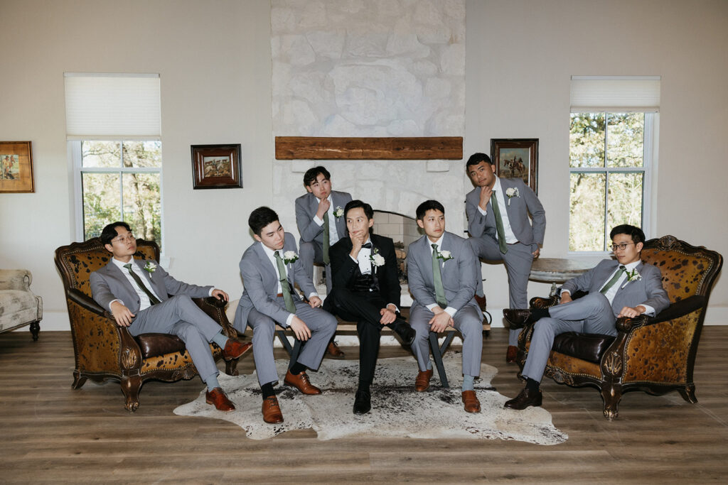 Groomsmen posing together in a suite at Bella Cavalli Events.