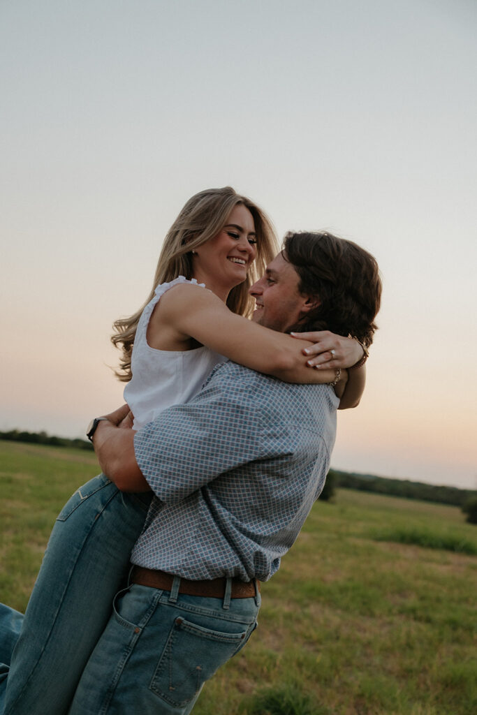 A man spinning his fiancée around.