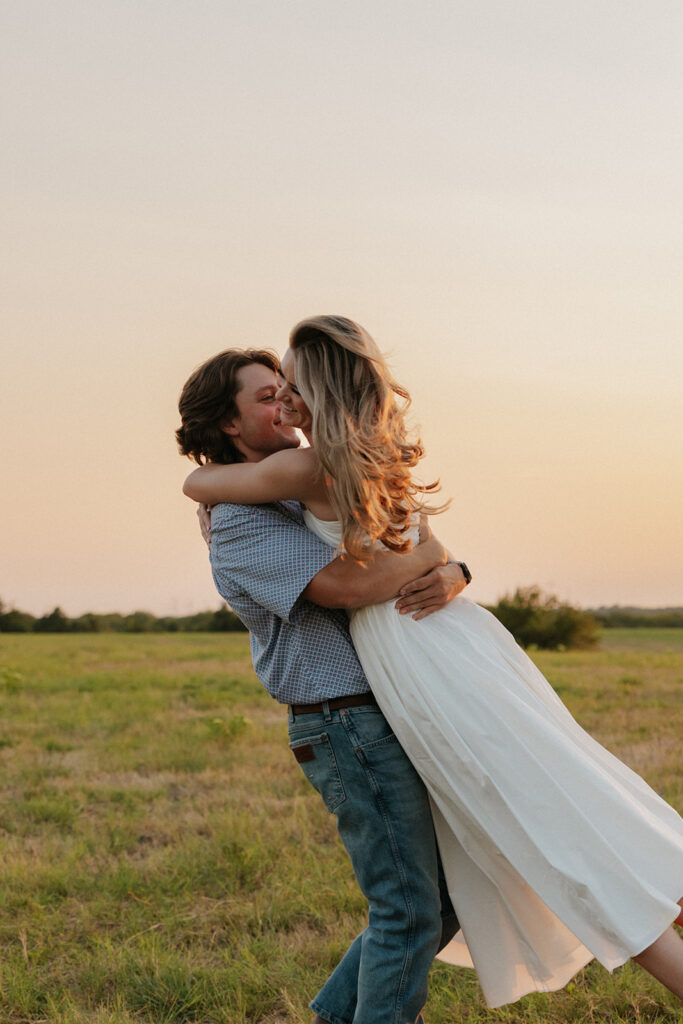 Dallas engagement photography of a couple spinning in a field.