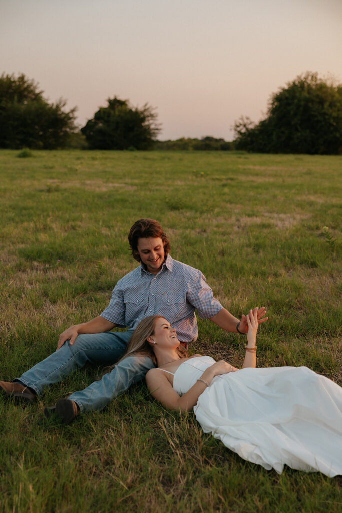 A couple laying in grass for Dallas engagement photography.