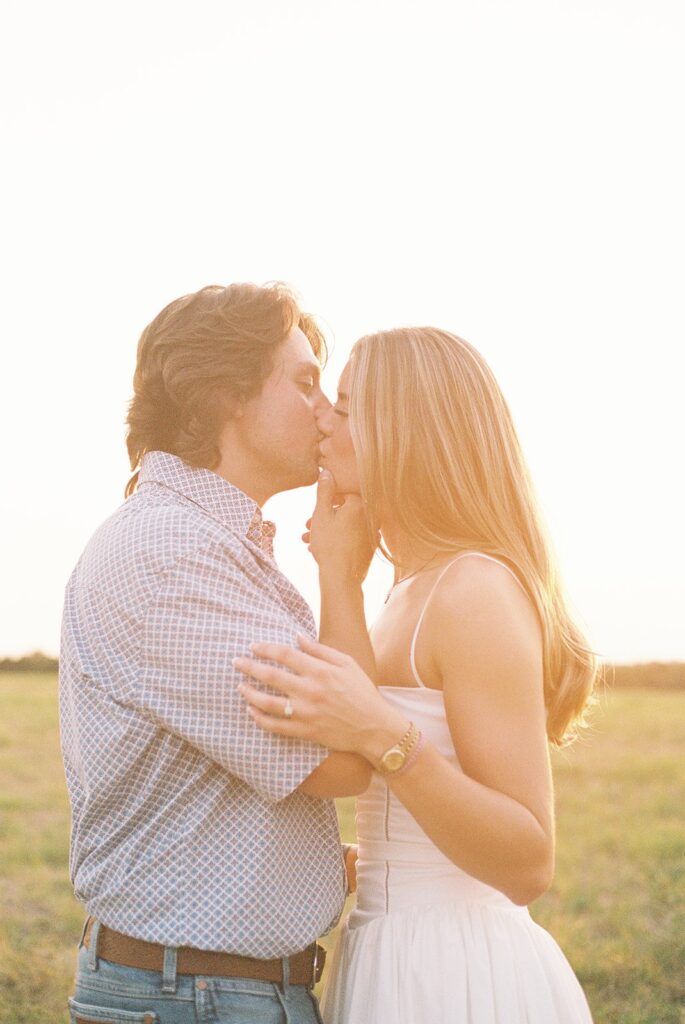 A couple kissing during golden hour.