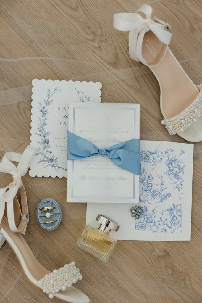 Wedding stationary, heels, perfume, and jewelry. 