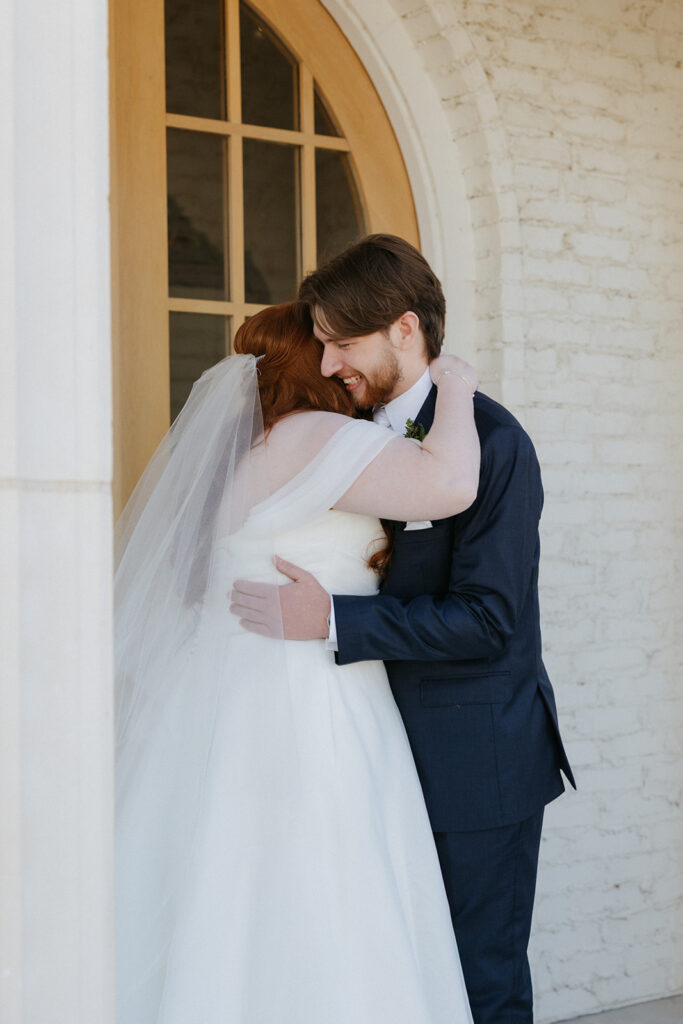 Bride and groom hugging during their first look.