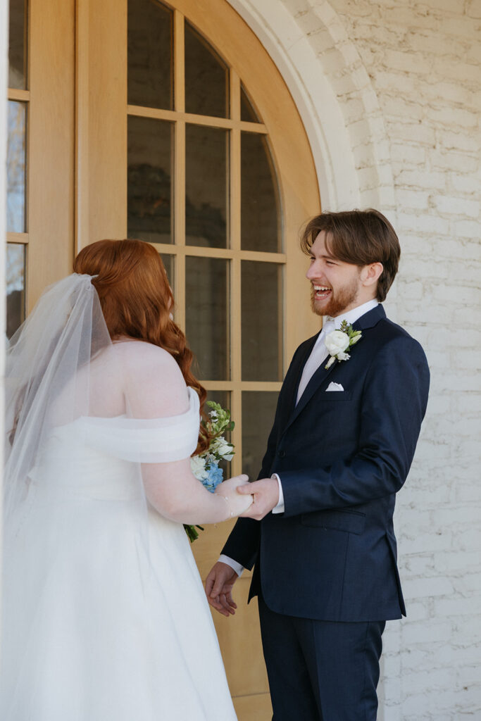 Bride and groom laughing during their first look.