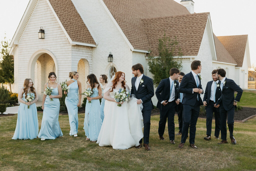 Wedding party walking and laughing.