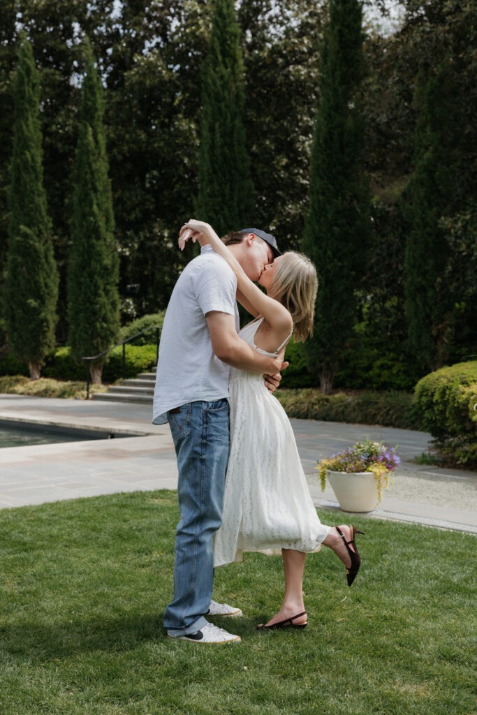 A couple kissing in the garden. 