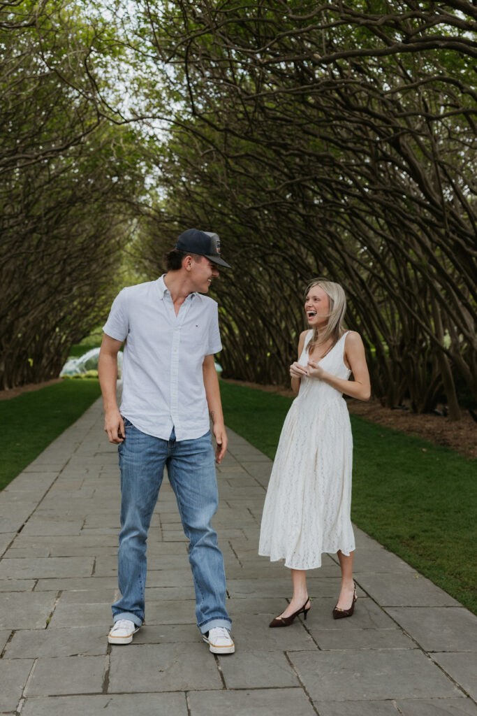 A couple laughing together during the Dallas Arboretum and Botanical Garden proposal.