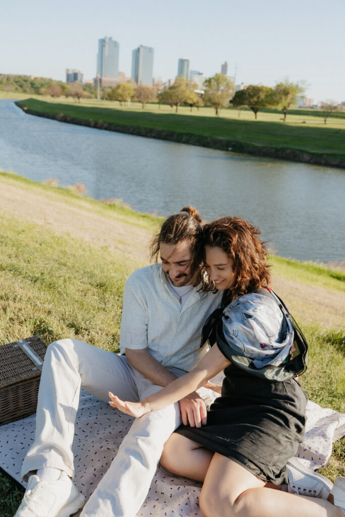A couple admiring the engagement ring on her hand at Trinity Lake. 