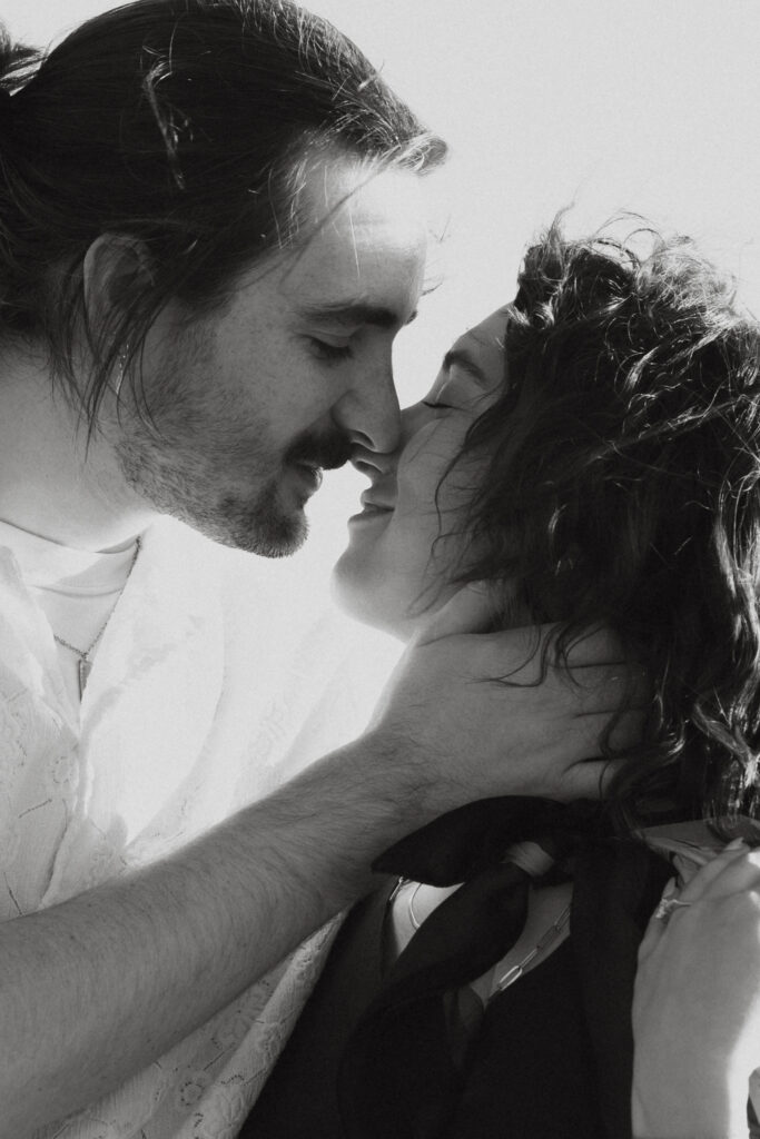 An engaged couple about to kiss.