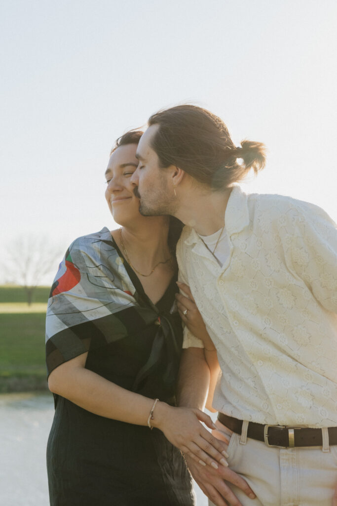 A man kissing his fiancée at one of the best places to propose in Fort Worth, Texas.