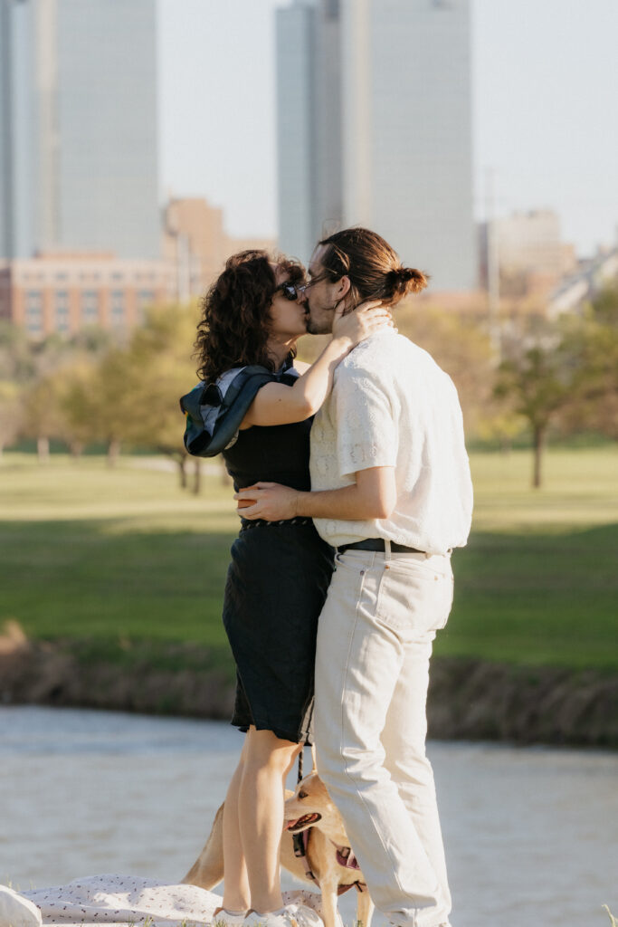 A couple kissing during their surprise proposal in downtown Fort Worth.