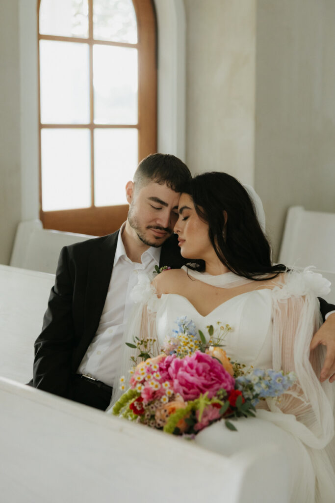A couple sitting in a chapel at The Emerson venue.