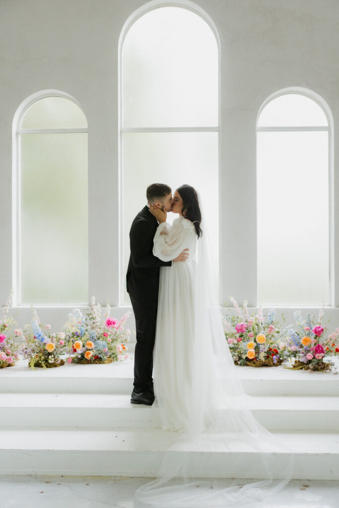 A couple kissing at The Emerson, one of the top DFW wedding venues.