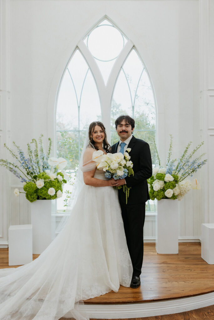 Bride and groom smiling at the altar of their ceremony. 
