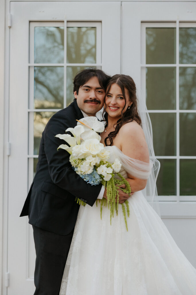 Groom hugging his bride outside of The Springs Valley View Estate.