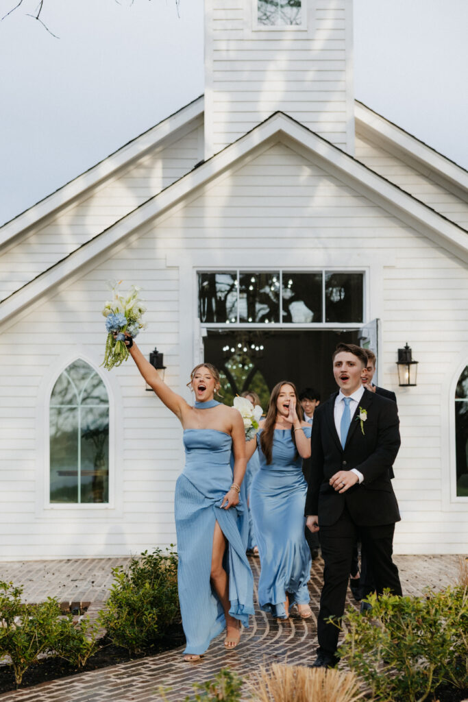 Wedding party celebrating as they exit the chapel. 