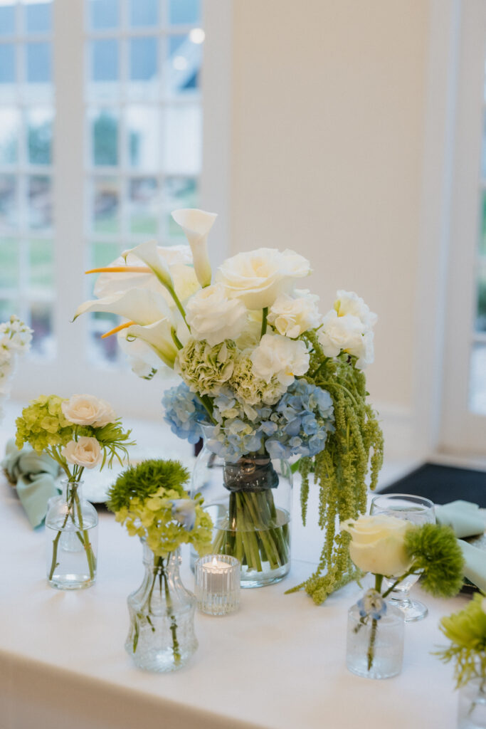 Blue and groom floral arrangements at cocktail hour. 
