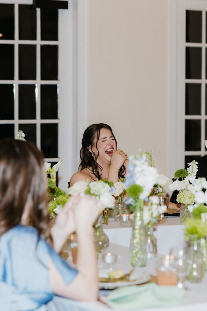 Bride laughing really hard during speeches. 