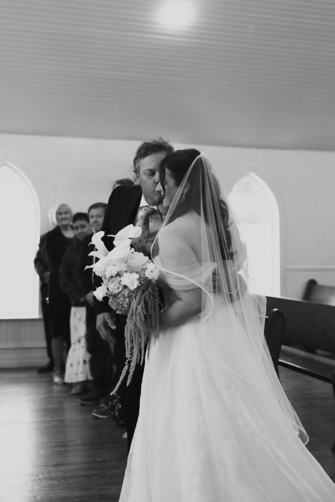 Father of the bride kissing the bride's cheek during the ceremony at The Springs Valley View Estate.