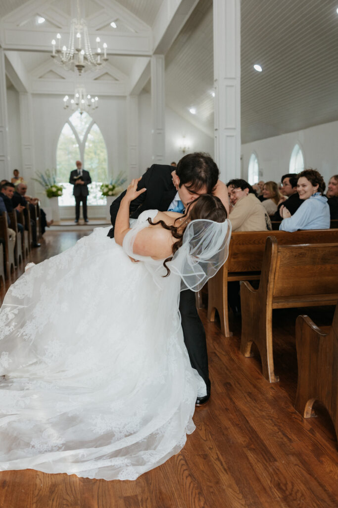 Bride and groom kissing at the end of the aisle at The Springs Valley View Estate.