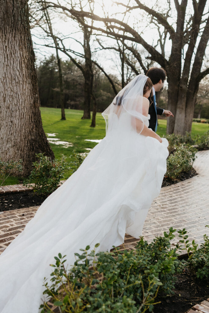 Bride and groom walking away in the rain. 