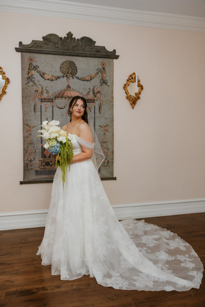 Bridal looking off into the distance, holding flowers.