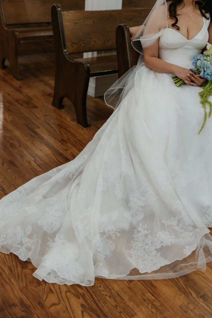 Bride sitting in a pew at the The Springs Valley View Estate wedding venue in DFW.